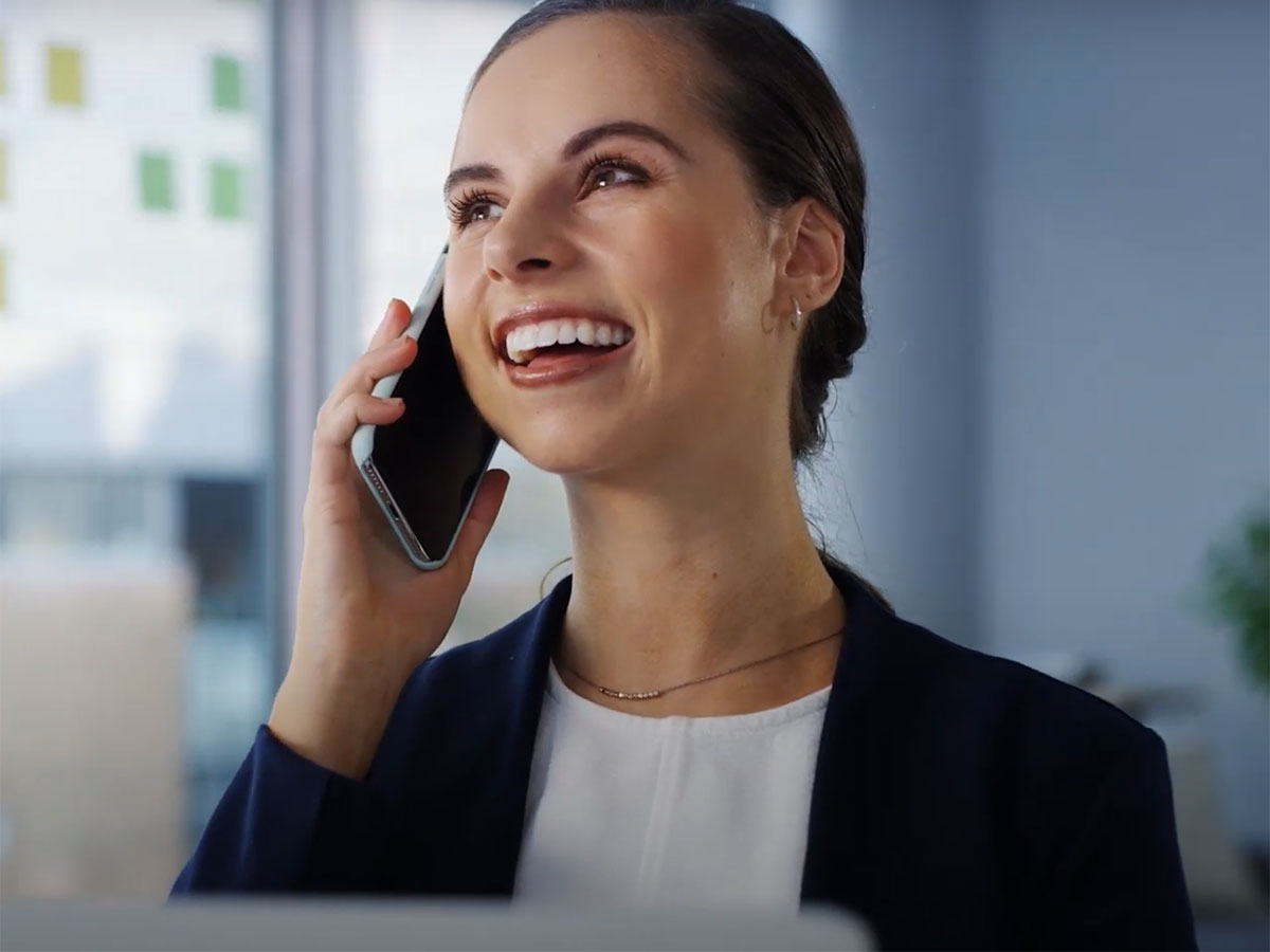 thumbnail from the video showing a woman speaking on the phone